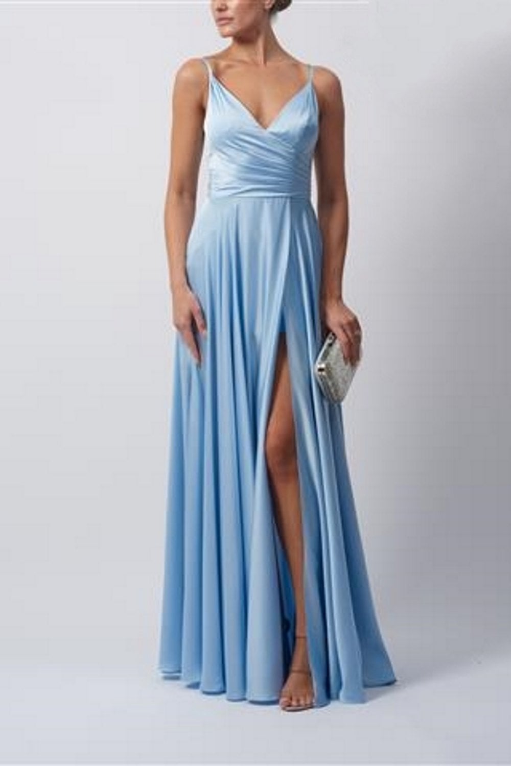 Model wearing Baby Blue Satin Pleat Prom Dress by Mascara London, front view with high leg split