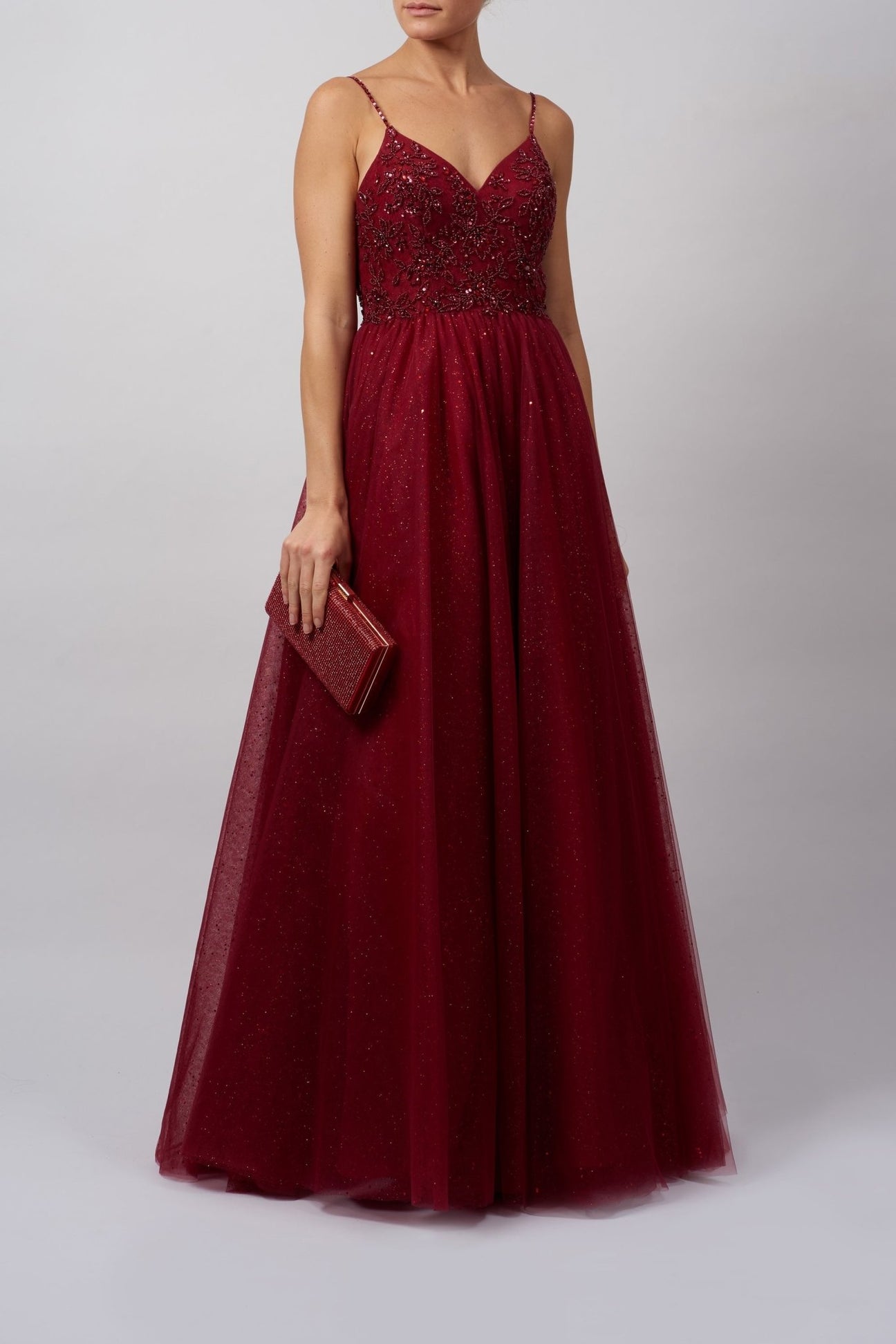 Young female standing in a Wine Tulle strap prom dress